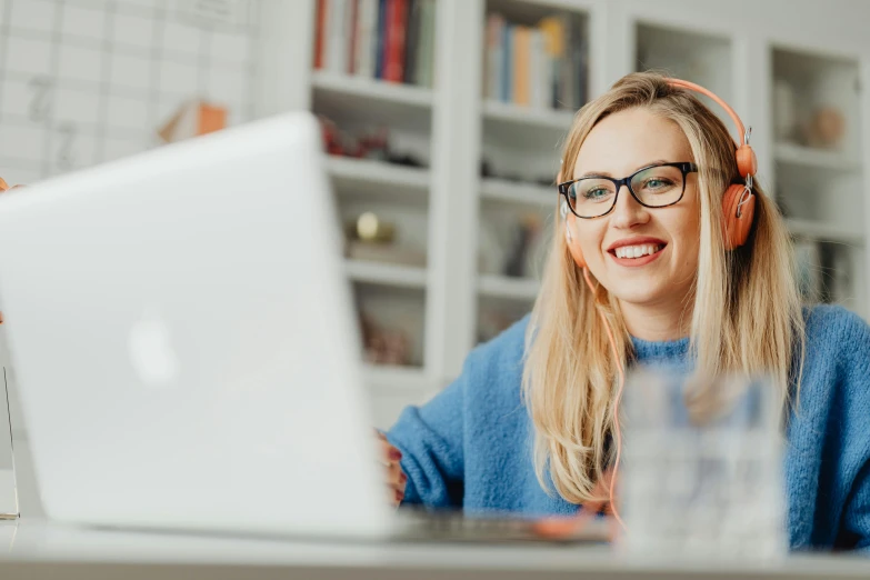 a woman sitting in front of a laptop computer, a portrait, trending on pexels, cute slightly nerdy smile, blippi, a blond, librarian