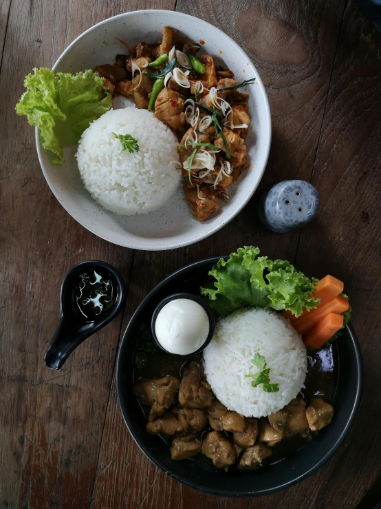 a wooden table topped with two bowls of food, a picture, unsplash, dau-al-set, chicken, thumbnail, jakarta, white and black