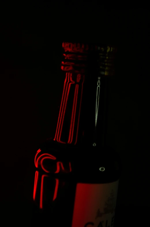 a bottle of wine sitting on top of a table, a raytraced image, by Doug Ohlson, pexels, shining gold and black and red, lightpainting luminescent, medium format. soft light, beer bottles