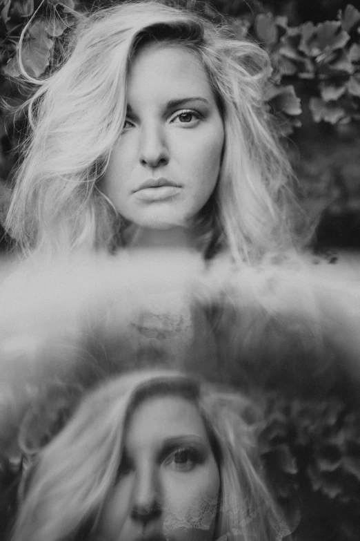 a black and white photo of a woman with long hair, a black and white photo, inspired by Emil Fuchs, mirrored, close up of a blonde woman, epic. 1 0 0 mm, with a twin