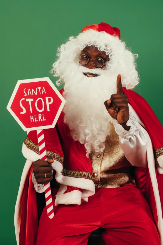 a man dressed as santa claus holding a stop sign, a photo, pexels, black man, 🎀 🗡 🍓 🧚, gif, promo material