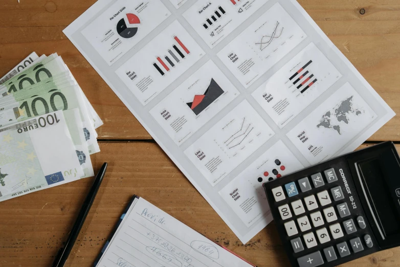 a calculator sitting on top of a wooden table, a picture, trending on unsplash, analytical art, character sheets on table, with illustrations and diagrams, asset on grey background, printed on paper