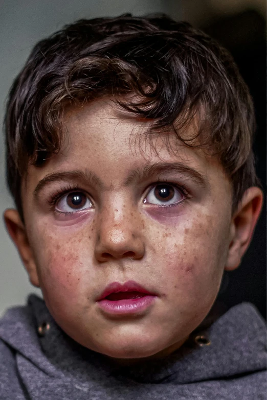 a close up of a child wearing a hoodie, by Micha Klein, weathered olive skin, portait image