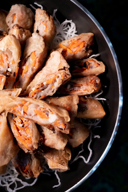 a close up of a bowl of food on a table, floating chinese lampoons, wrapped arms, orange fluffy spines, thumbnail