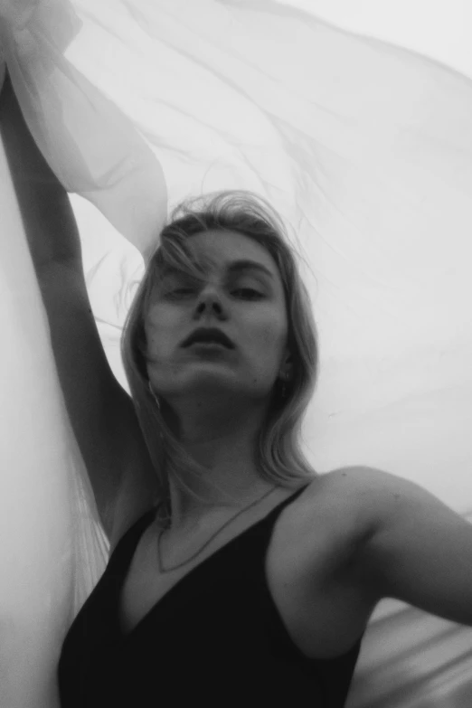 a black and white photo of a woman with a veil, a black and white photo, unsplash, realism, petra collins and mc. escher, sexy pose, angie glocka, caroline gariba