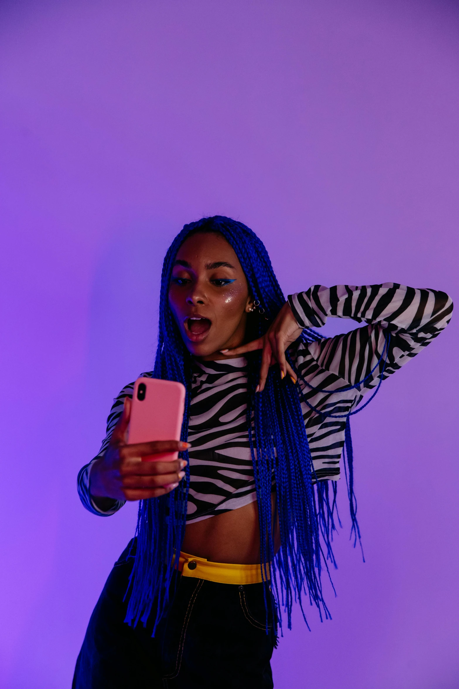 a woman with blue hair taking a selfie, an album cover, trending on pexels, soft neon purple lighting, aida muluneh, threatening pose, phone photo