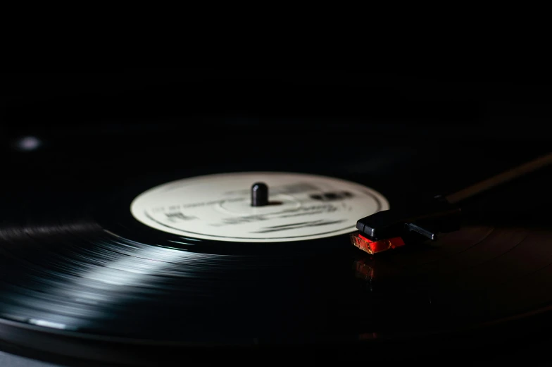a vinyl record sitting on top of a table, by Niko Henrichon, pexels contest winner, white on black, 15081959 21121991 01012000 4k, black lacquer, first light