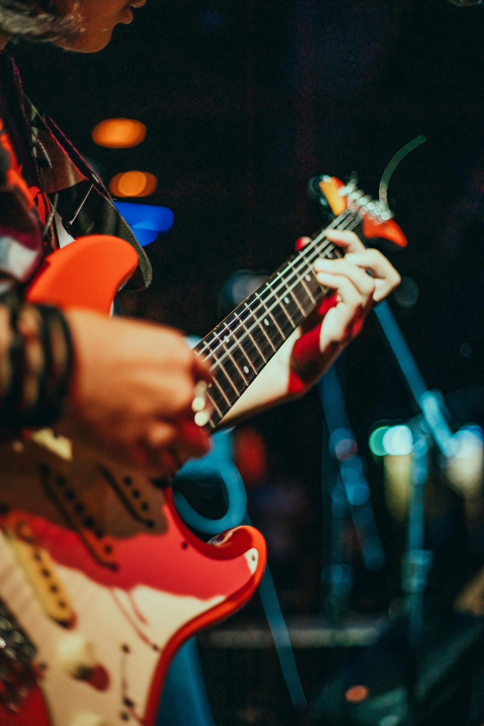 a close up of a person playing a guitar, happening, profile image, rocking out, zoomed in, nightlife