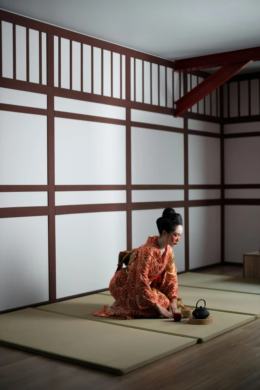 a woman in a kimono sitting on the floor, in a dojo, bay area, square, image