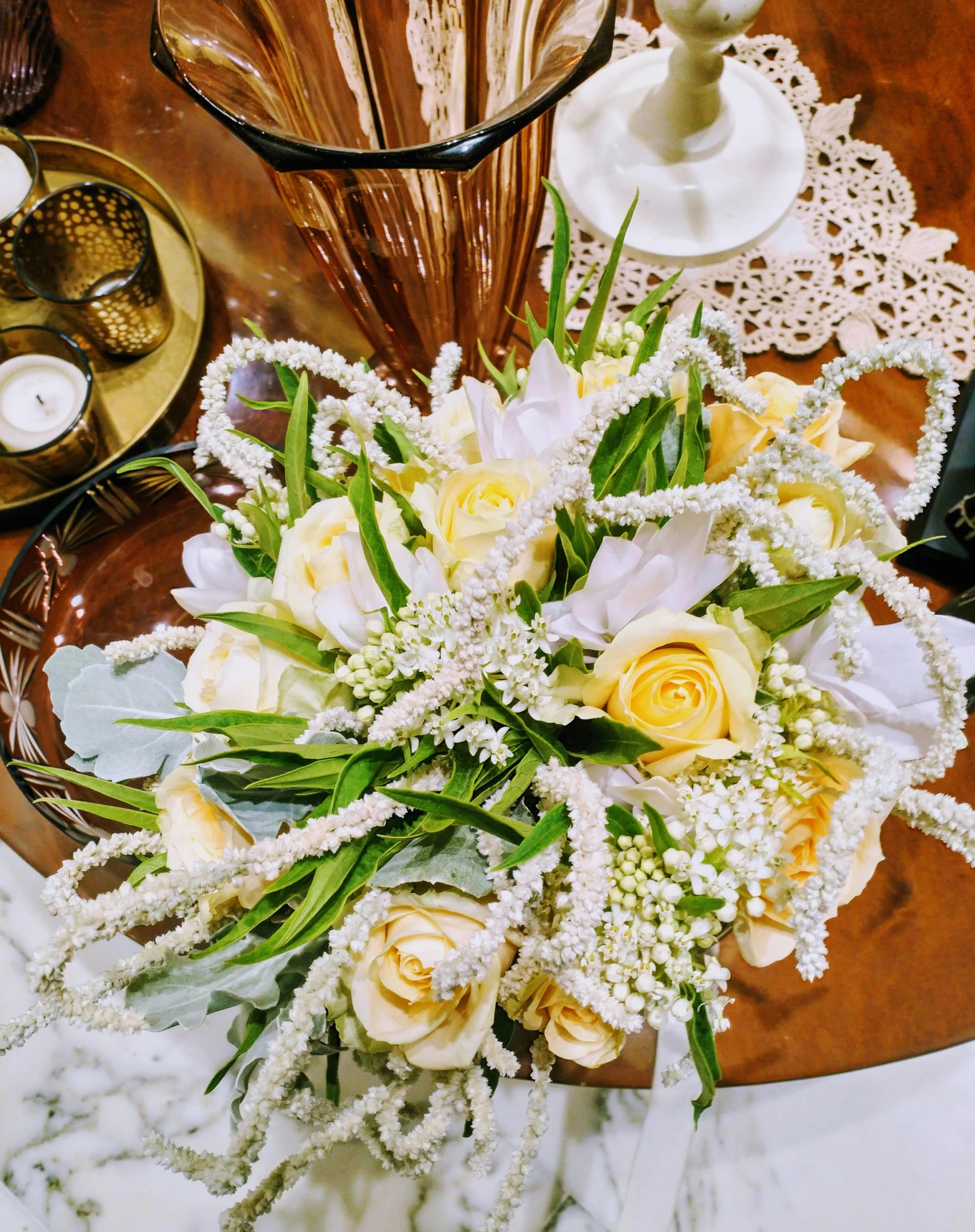 a bouquet of flowers sitting on top of a table, inspired by Louis Comfort Tiffany, white and yellow scheme, birdseye view, fully decorated, displayed