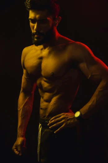 a shirtless man standing in front of a red light, by Terrell James, pexels contest winner, renaissance, abdominal muscles, dark. studio lighting, bearded and built, instagram picture