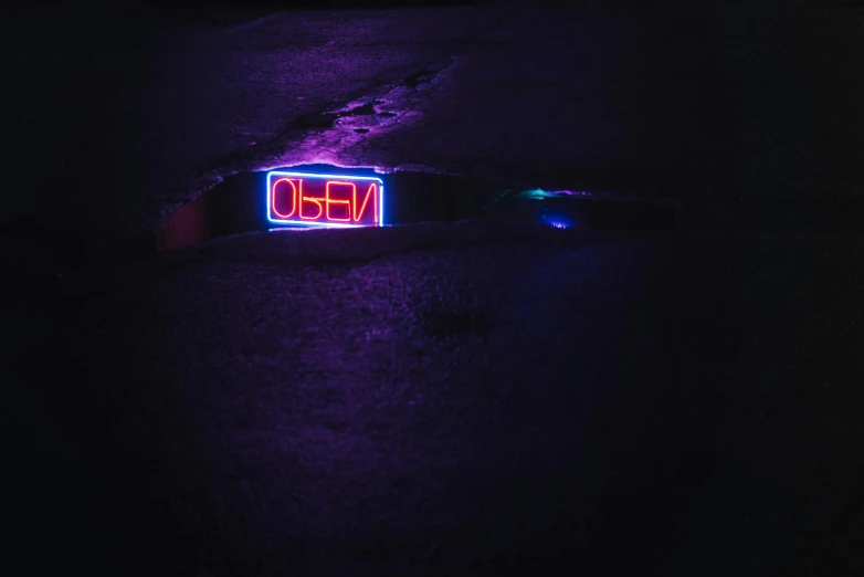 a neon sign sitting on the side of a road, an album cover, inspired by Elsa Bleda, unsplash, neoism, \'obey\', purple bioluminescence, photo 35mm, sergey vasnev