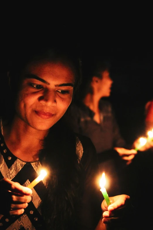 a group of people holding lit candles in their hands, slide show, sri lanka, profile image, lesbians