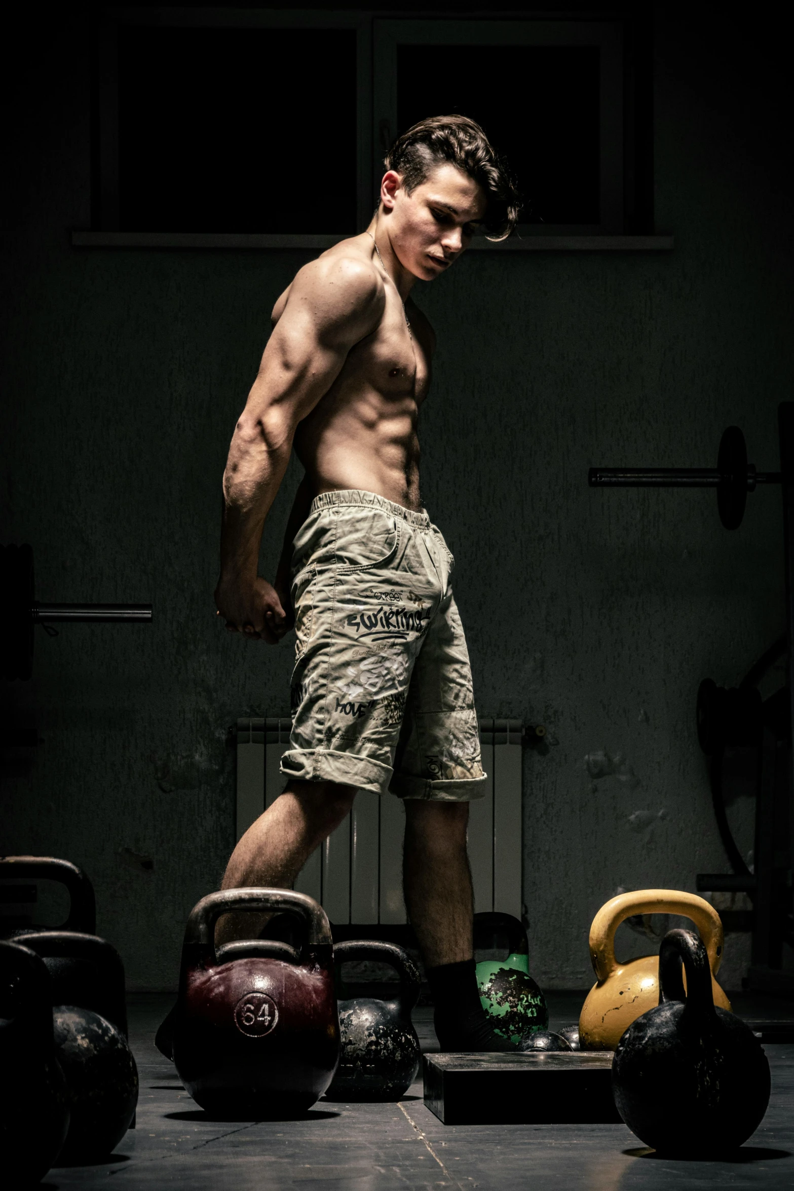 a shirtless man standing in front of kettles, pexels contest winner, muscular legs, strong lights, conor walton, headshot