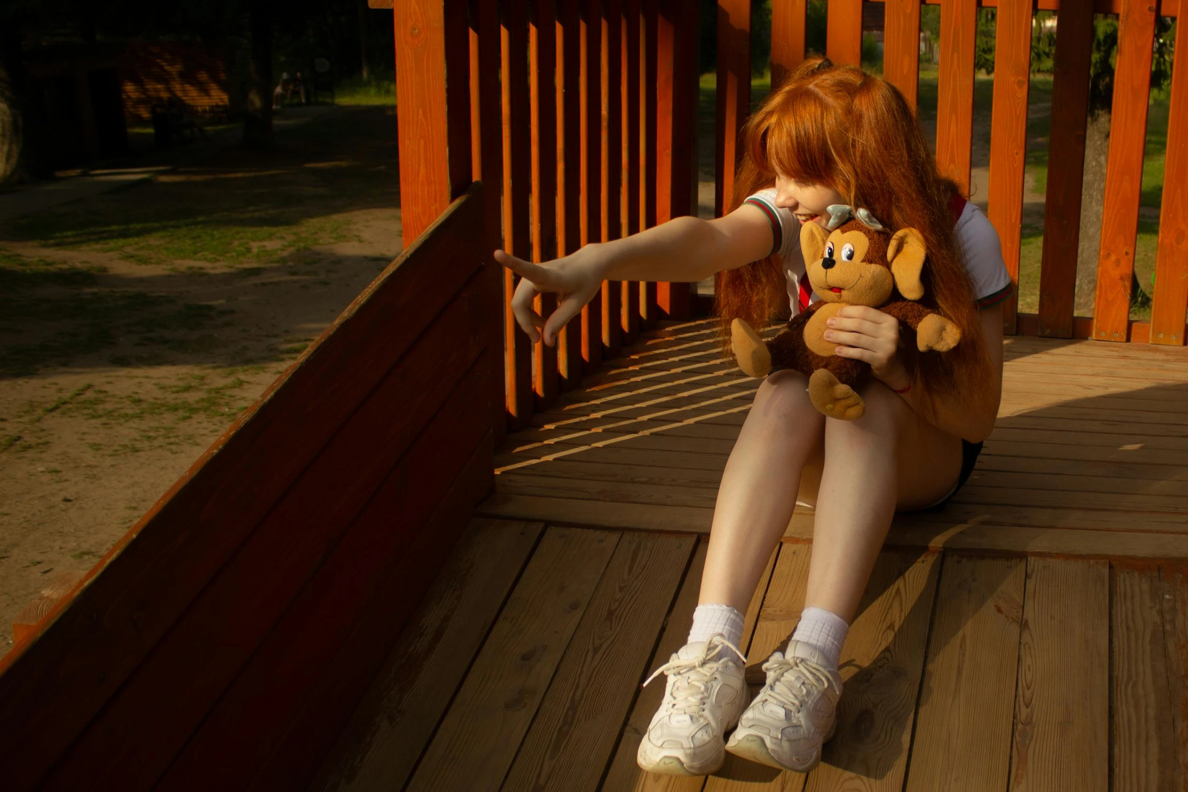 a woman sitting on a wooden deck holding a teddy bear, unsplash, realism, asuka langley sohryu, nightmare in the park, ball jointed doll, depressing image