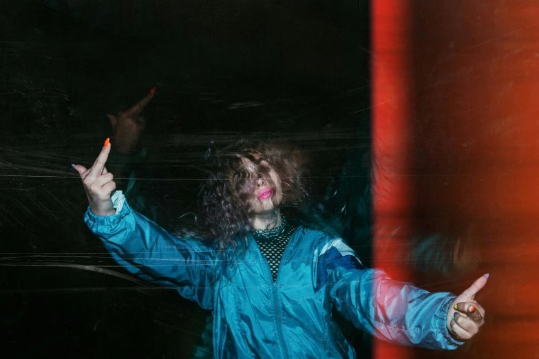 a man in a blue jacket holding a cigarette, an album cover, inspired by Elsa Bleda, trending on pexels, graffiti, wavy hair spread out, raver girl, hands up, night photo