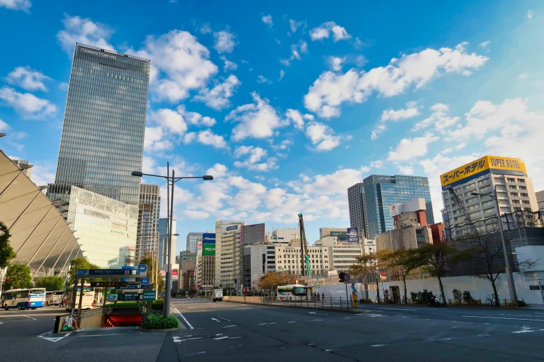 a bus driving down a street next to tall buildings, sōsaku hanga, blue sky, square, high quality picture, capital plaza