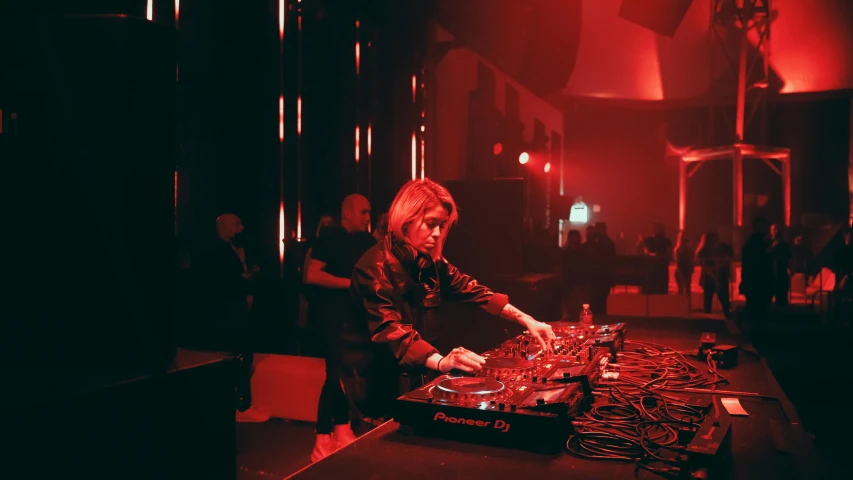 a man that is standing in front of a table, an album cover, unsplash, wonderfull techno party, portrait a woman like reol, performing on stage, sofia coppola