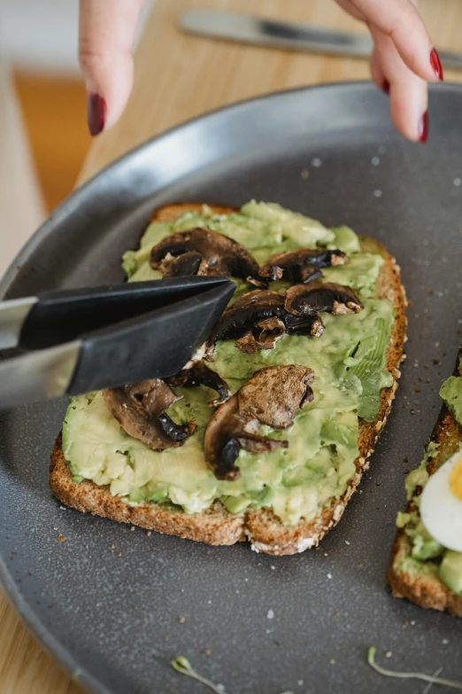 a person cutting an avocado toast with a knife, a portrait, trending on pexels, brown bread with sliced salo, plated, grey, a brightly coloured