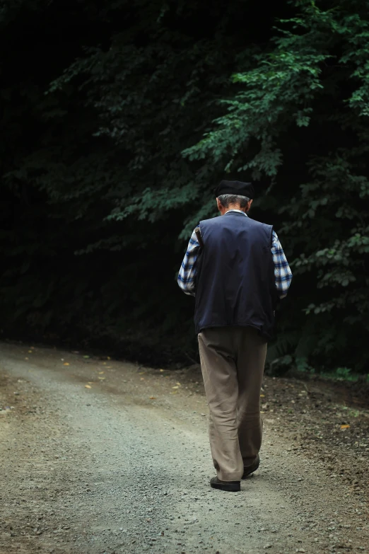 a man walking down a dirt road in the woods, looking old, grandfatherly, remembering his life, promo image