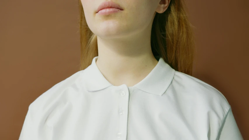 a close up of a person wearing a white shirt, inspired by Vanessa Beecroft, wearing polo shirt, female lead character, with round face, minimal clothing