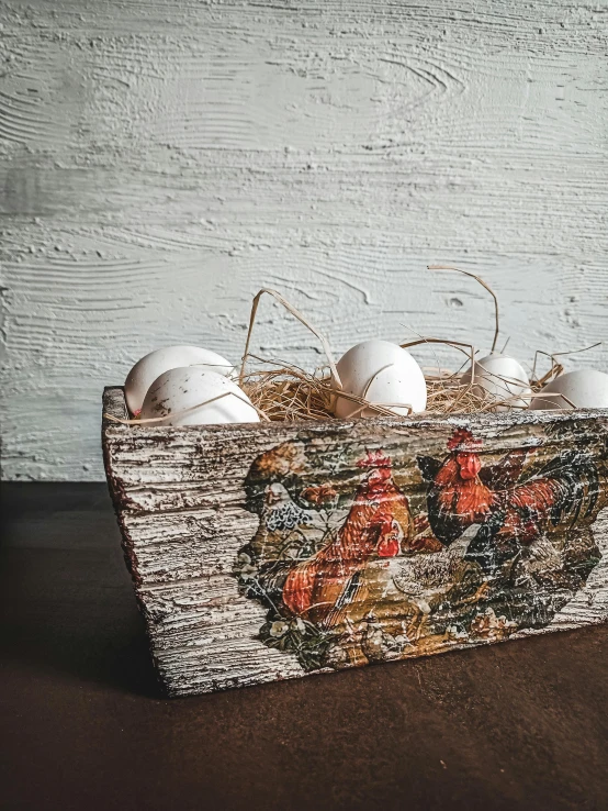 a wooden box filled with eggs sitting on top of a table, inspired by Eden Box, renaissance, front shot, farm, white, detailed product image