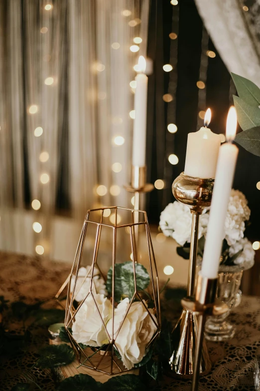 a couple of candles sitting on top of a table, gold accents, lots of lights, multiple details, detail shot