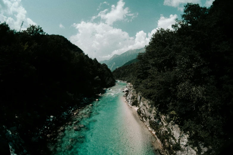 a river running through a lush green forest filled with trees, pexels contest winner, turquoise gradient, slovenian, album cover, blue waters