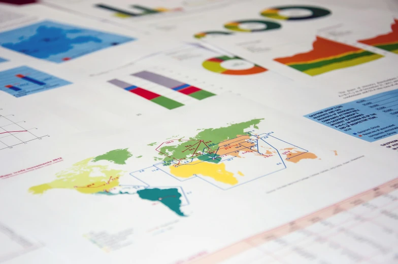 a close up of a map of the world, a poster, by Daniel Lieske, trending on unsplash, international typographic style, bar charts, character sheets on table, multi - coloured, fzd school of design