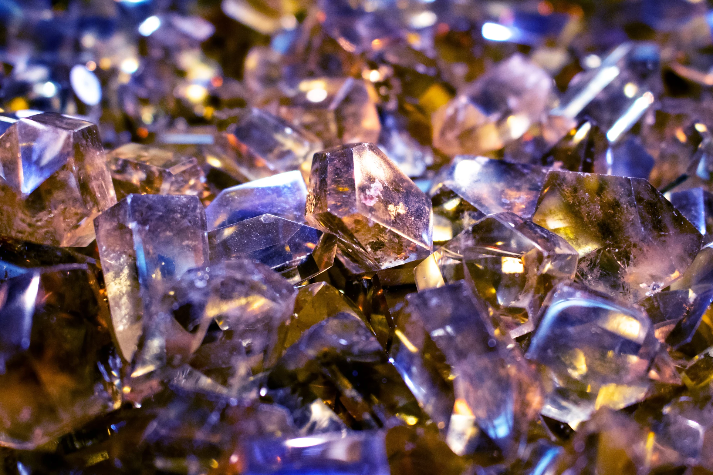 a pile of ice crystals sitting on top of a table, by Jeanna bauck, pexels, crystal cubism, purple and gold color scheme, brown, glass beads, diamond