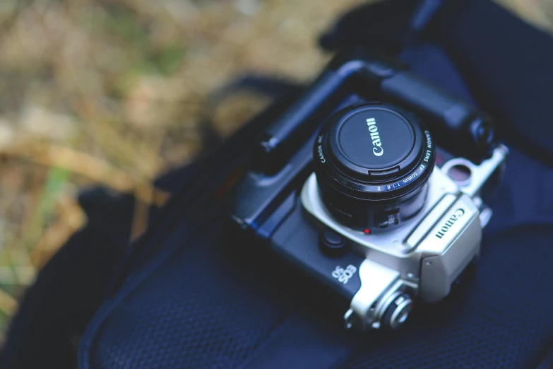 a camera sitting on top of a backpack, unsplash, canon a1, medium format, photography”