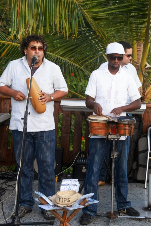 a group of men standing next to each other playing musical instruments, happening, aruba, john picacio and brom, performing, in 2 0 1 2
