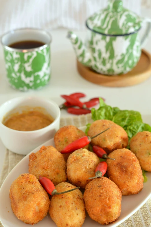 a white plate topped with fried food next to a cup of coffee, inspired by Ruth Jên, dau-al-set, jajaboonords flipjimtots, thumbnail, vietnam, stuffed