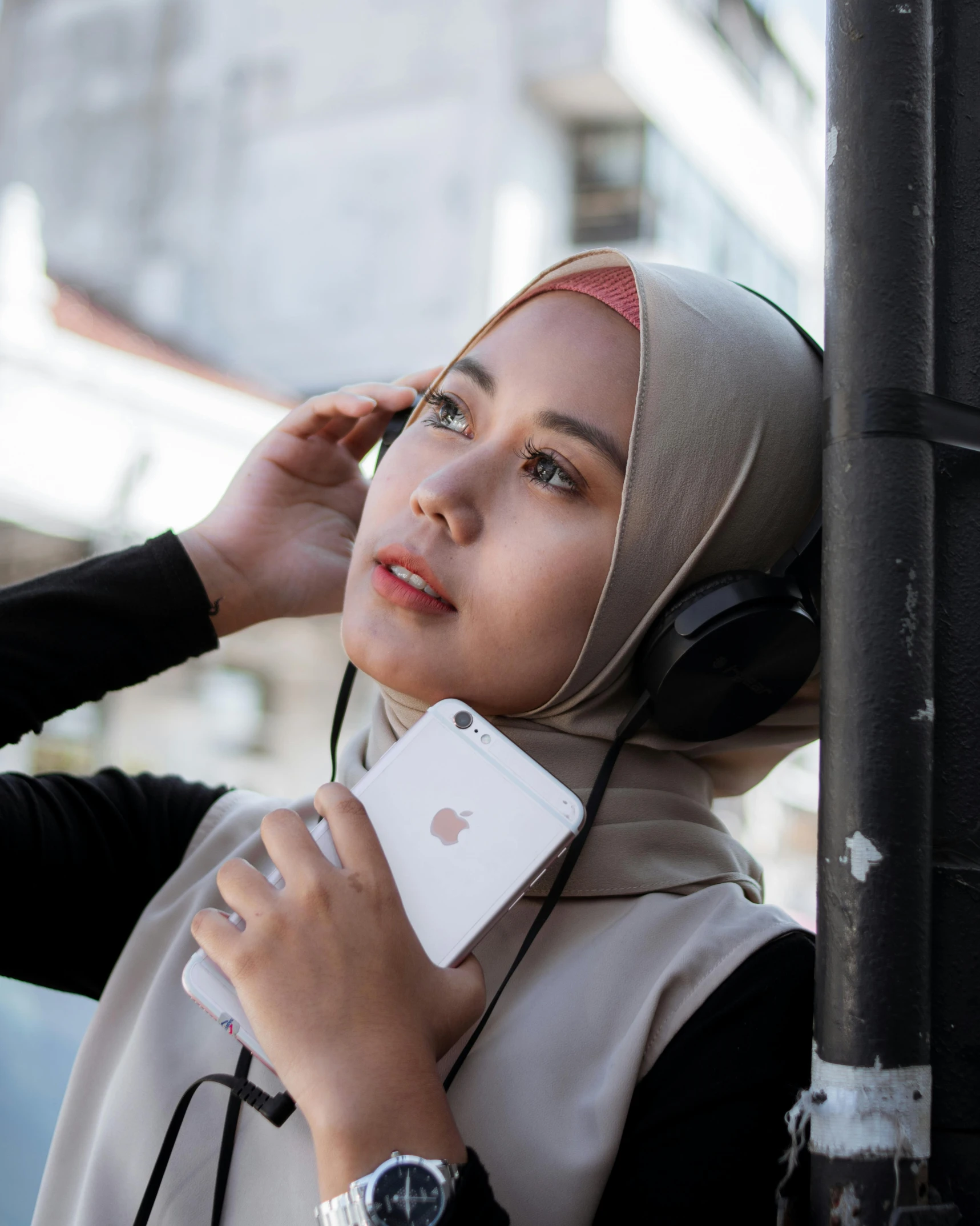 a woman wearing a hijab talking on a cell phone, inspired by Bernardino Mei, trending on pexels, wearing cat ear headphones, lgbt, asian human, professional iphone photo