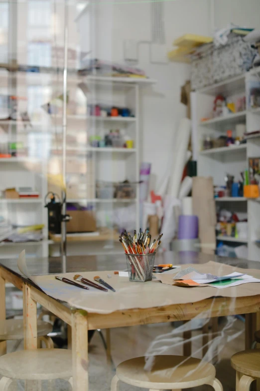 a table and some chairs in a room, a child's drawing, trending on pexels, arbeitsrat für kunst, inside a cluttered art studio, interior of a library, art supplies, profile image