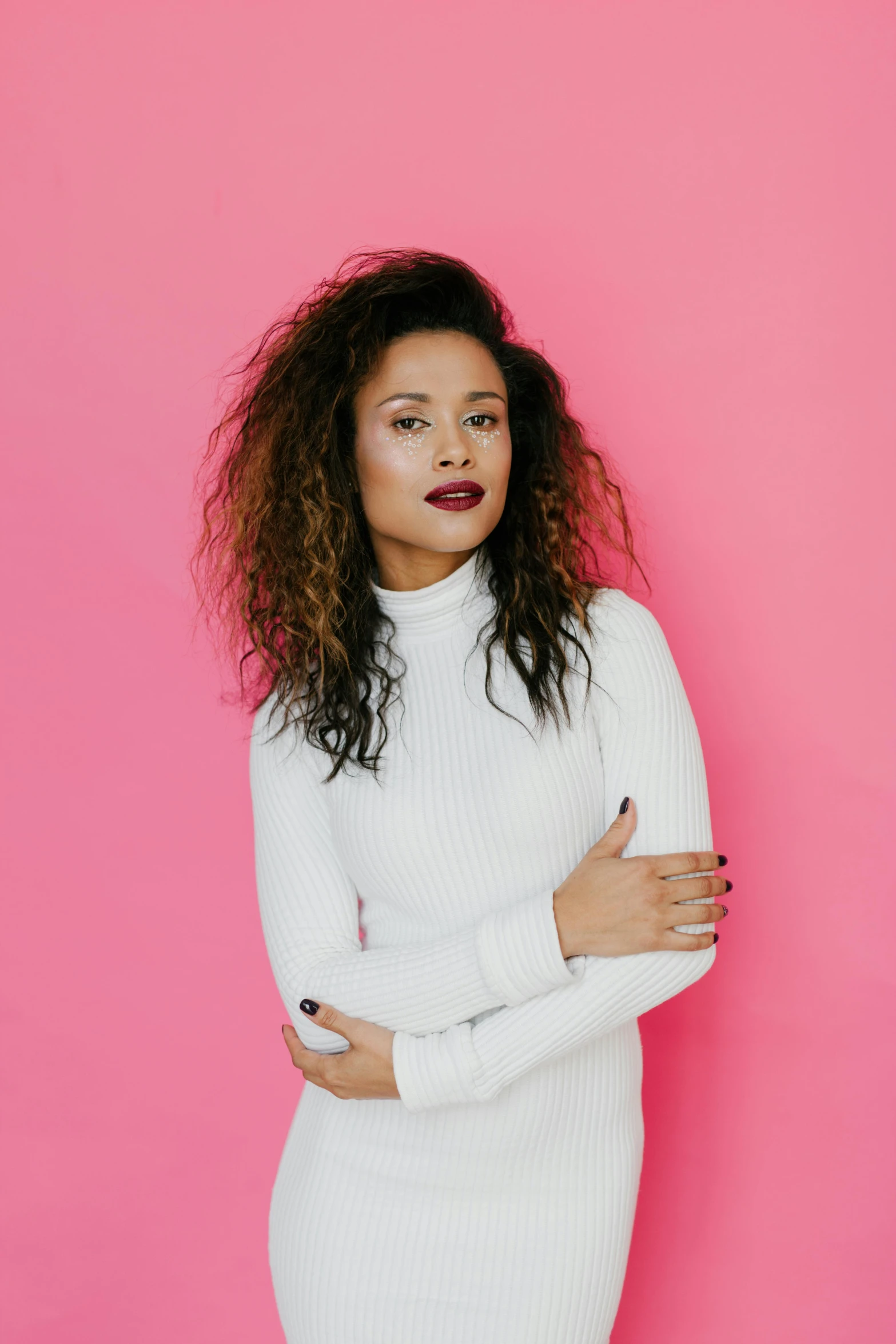 a woman standing in front of a pink wall, an album cover, in white turtleneck shirt, mixed race, pose 4 of 1 6, mixed race woman