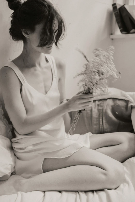 a black and white photo of a woman sitting on a bed, inspired by Anka Zhuravleva, pexels contest winner, holding flowers, kiko mizuhara, summer evening, lo fi