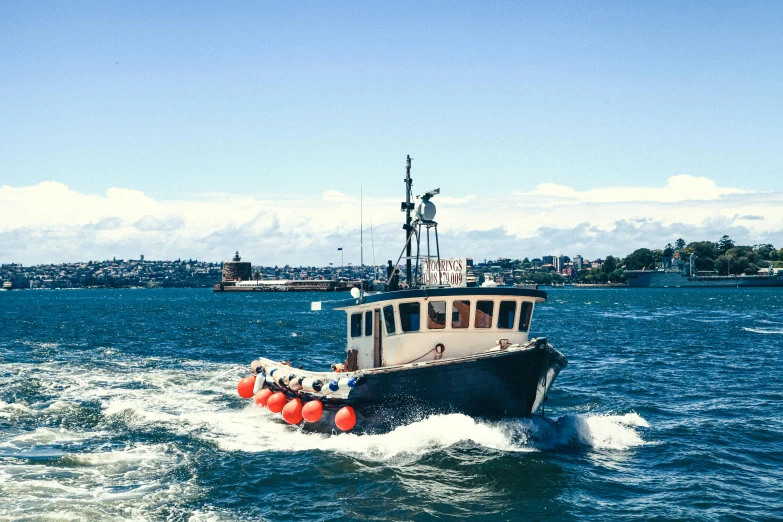 a boat traveling across a body of water, by Simon Marmion, pexels contest winner, hurufiyya, sydney, salmon, nautical siren, ballard