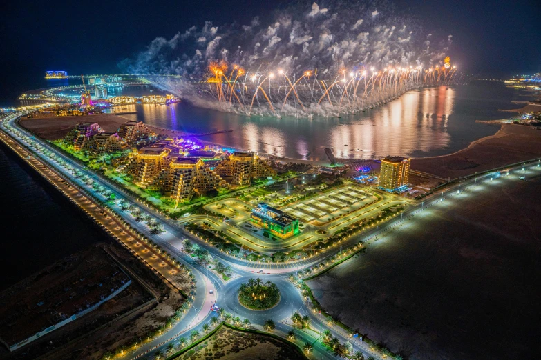 fireworks light up the sky over a city at night, by Abdullah Gërguri, pexels contest winner, shipyard, aerial photography, arabian features, sports photo