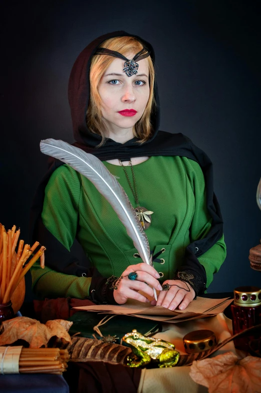 a woman dressed as a witch writing on a piece of paper, a character portrait, inspired by Master of the Legend of Saint Lucy, pexels contest winner, green tunic, male artificer, studio photo, a blonde emerald warrior