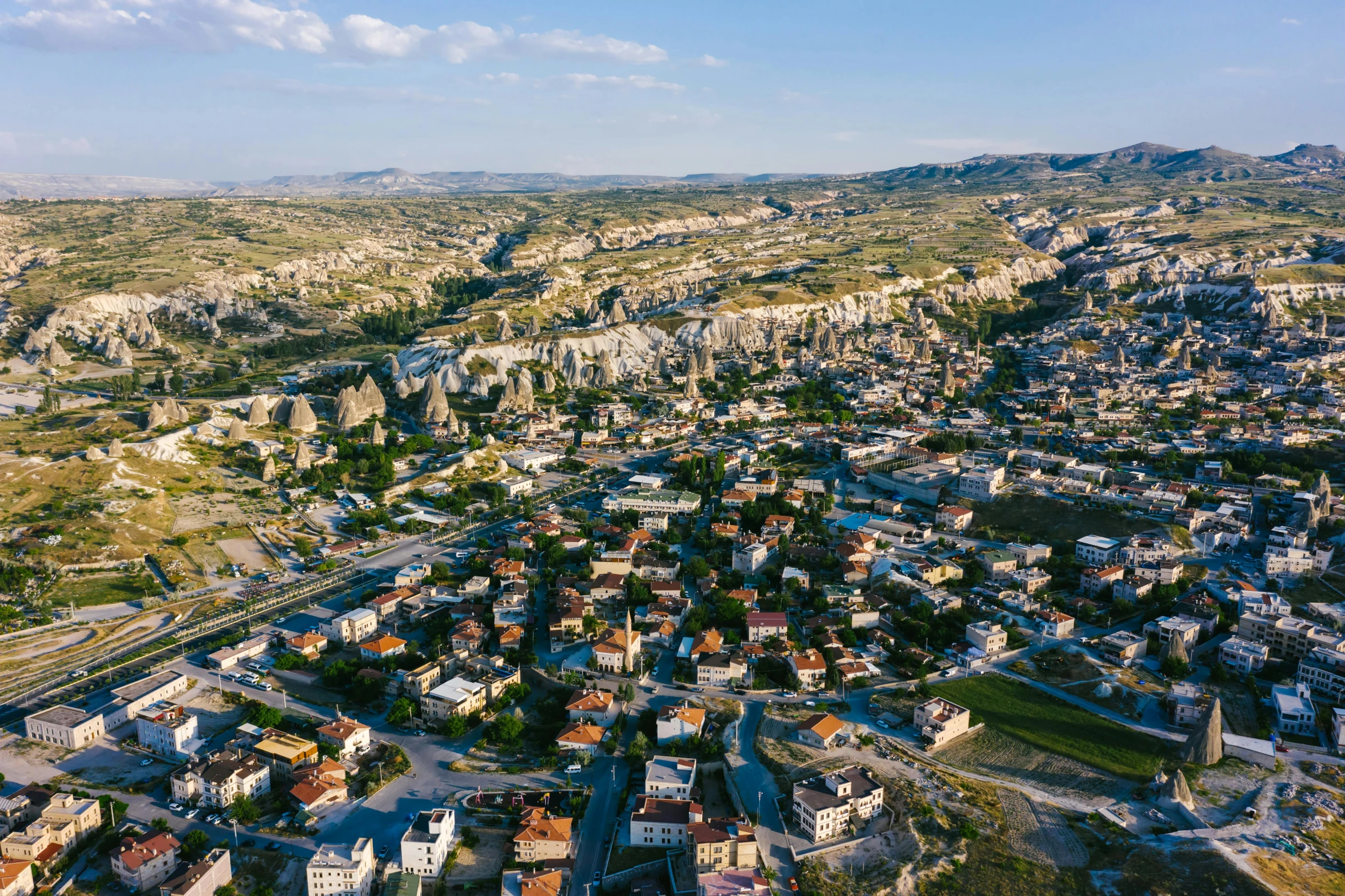 an aerial view of a small town in the mountains, an album cover, pexels contest winner, hurufiyya, turkey, chiseled formations, 4k footage, 2000s photo