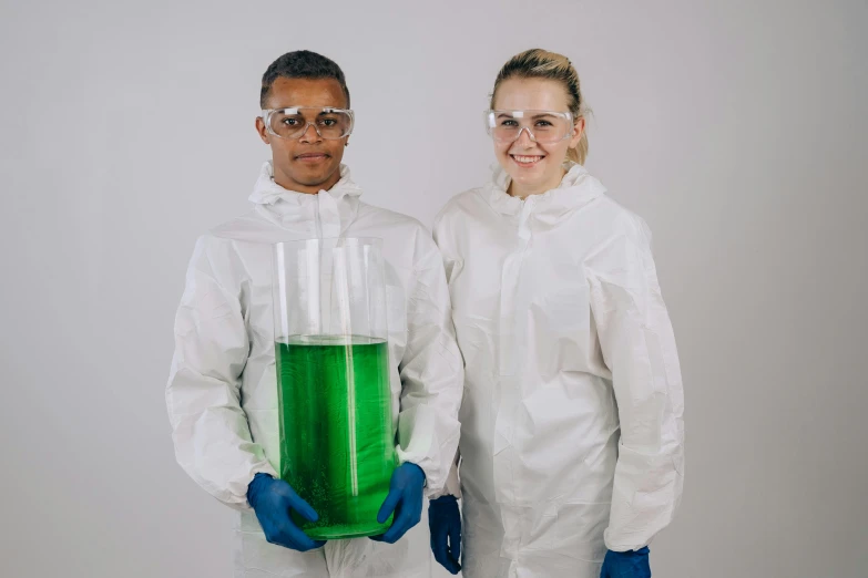 a couple of people standing next to each other, chemicals, green and white, academic clothing, transparent liquid