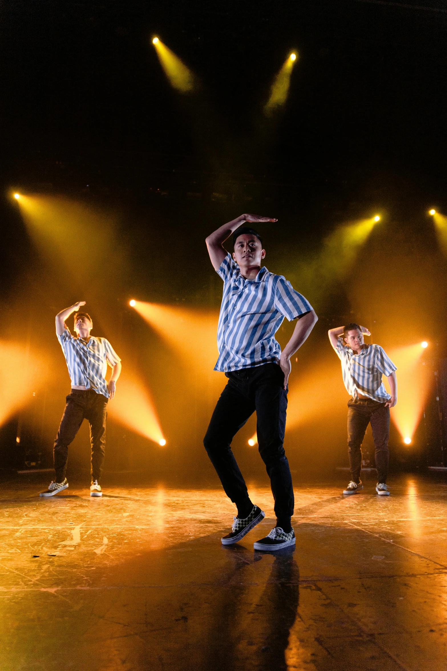 a group of young men standing on top of a stage, an album cover, pexels, happening, dynamic dancing pose, 3 actors on stage, teenage boy, multiple lights