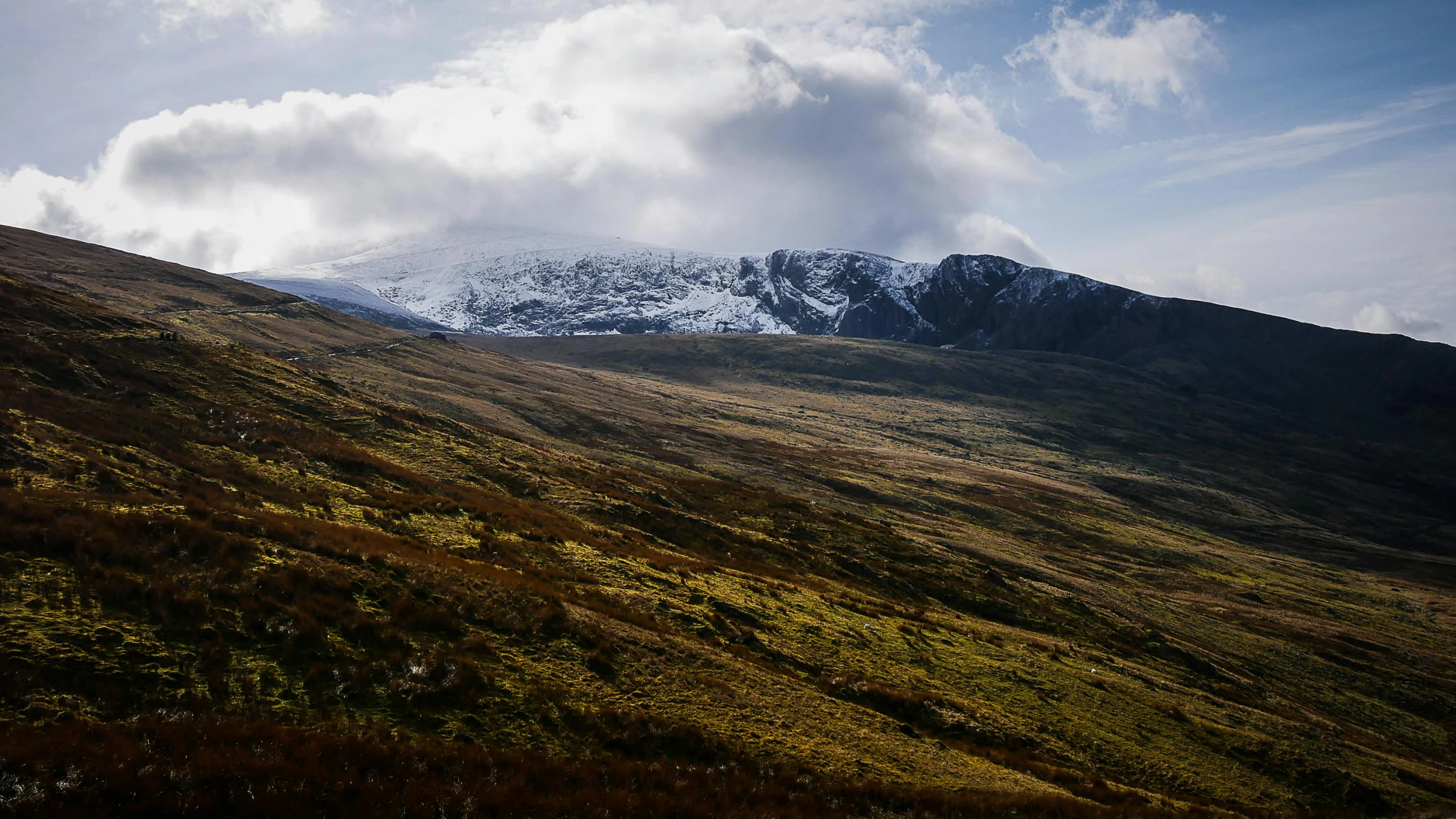 a snow covered mountain on a sunny day, by Bedwyr Williams, unsplash contest winner, hurufiyya, irish mountains background, thumbnail, shot on sony a 7, it's getting dark