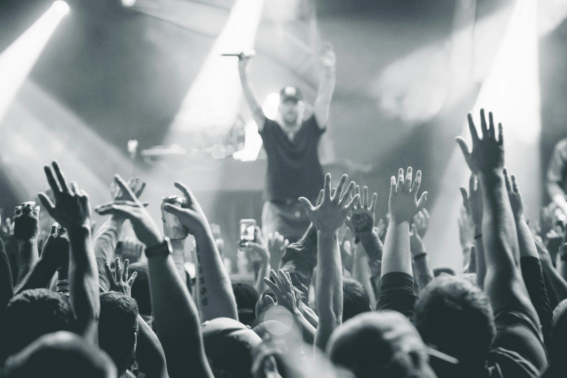 a crowd of people at a concert with their hands in the air, a black and white photo, pexels contest winner, marshal mathers, a photo of a man, promo image, jesus wasted at a party