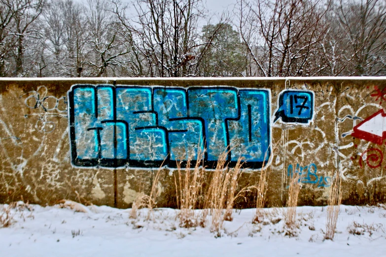 a wall that has some graffiti on it, by Joe Stefanelli, unsplash, graffiti, outside winter landscape, blue, 2 0 0 0's photo, instagram photo