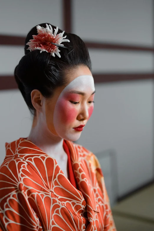 a woman in a kimono with a flower in her hair, a portrait, inspired by Otake Chikuha, trending on unsplash, white facepaint, square, white and orange, classic kabuki
