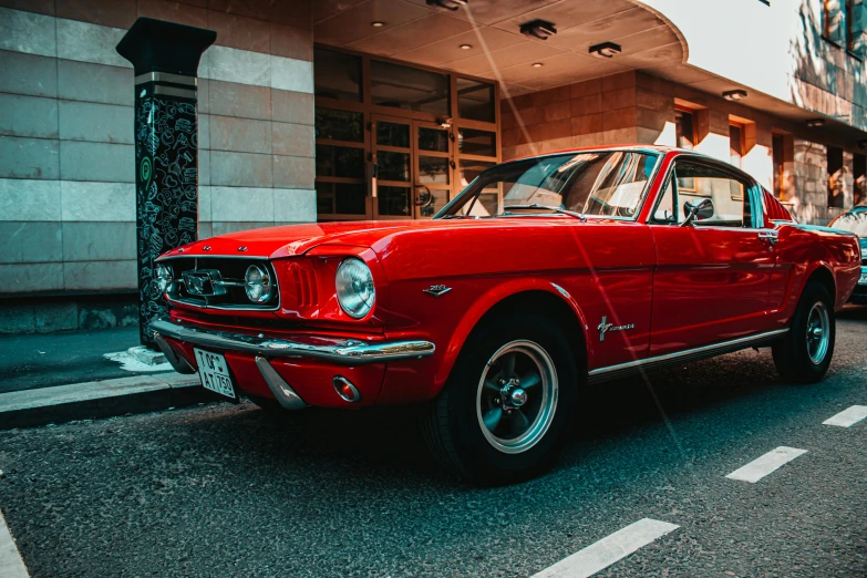 a red car parked in front of a building, pexels contest winner, mustang, 🦩🪐🐞👩🏻🦳, 1960s-era, front lit