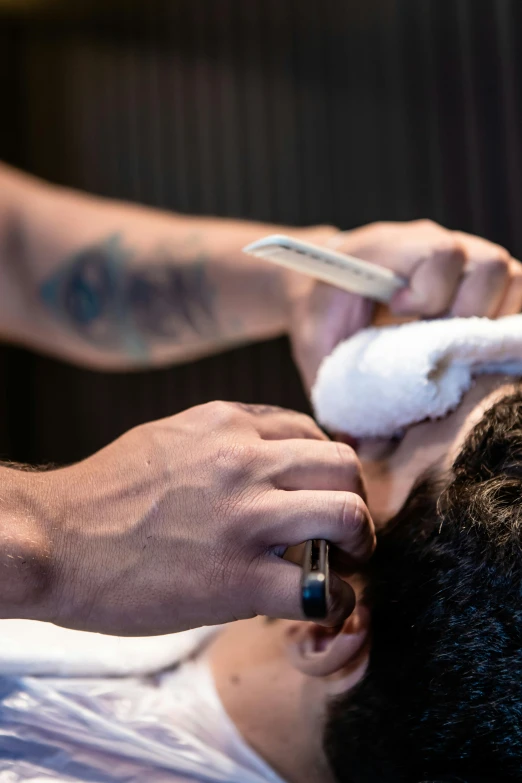 a man getting his hair cut at a barber shop, by Jay Hambidge, unsplash, ultra facial detail, hands shielding face, thumbnail, organic detail