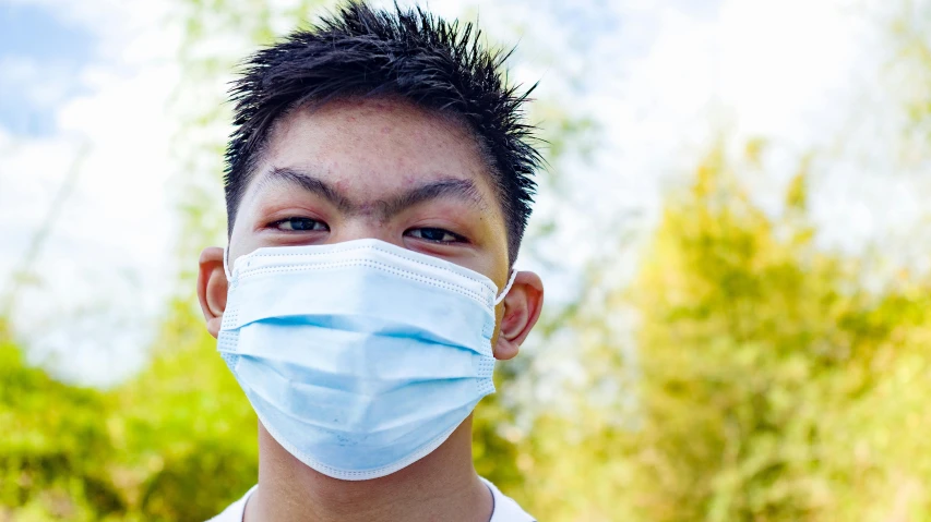 a close up of a person wearing a face mask, darren quach, teenage boy, diverse, surgery